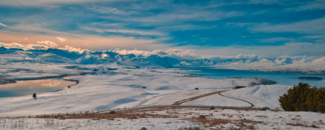 Snowy landscape, with lake, and mountain in background Snowy landscape, with lake, and mountain in background