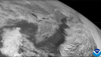 NOAA GOES-7 visible satellite imagery showing accumulated snowfall on March 14 from the 1993 Storm of the Century stretching from the Deep South into New England.