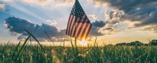 Photo of a field in the country with an American flag in it Photo of a field in the country with an American flag in it