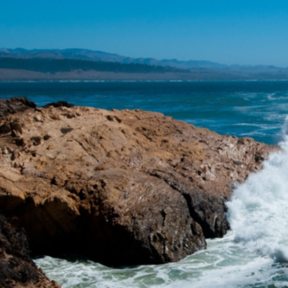 Ocean waves crashing on rocky shore.