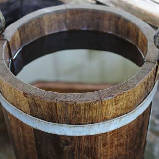 Photo of a wooden bucket filled with water