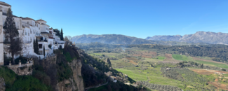 View of mountains and fields and part of the town of Ronda, Spain. View of mountains and fields and part of the town of Ronda, Spain.