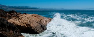 Ocean waves crashing on rocky shore. Ocean waves crashing on rocky shore.