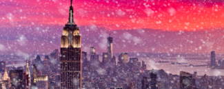 Snow falling in New York City with a vibrant pink and purple sunset in the background. Snow falling in New York City with a vibrant pink and purple sunset in the background.