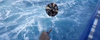 Drifting buoy being cast into ocean Drifting buoy being cast into ocean