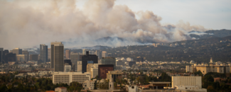 Wildfire in Pacific Palisades, Los Angeles on January 8, 2025. Image is from Koreatown towards Getty Center and Brentwood. Images showcase dense smoke clouds, burning hillsides and urban areas at risk.