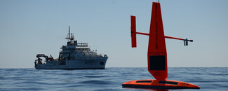 Saildrone and ship at sea. Saildrone and ship at sea.