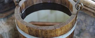 Photo of a wooden bucket filled with water Photo of a wooden bucket filled with water